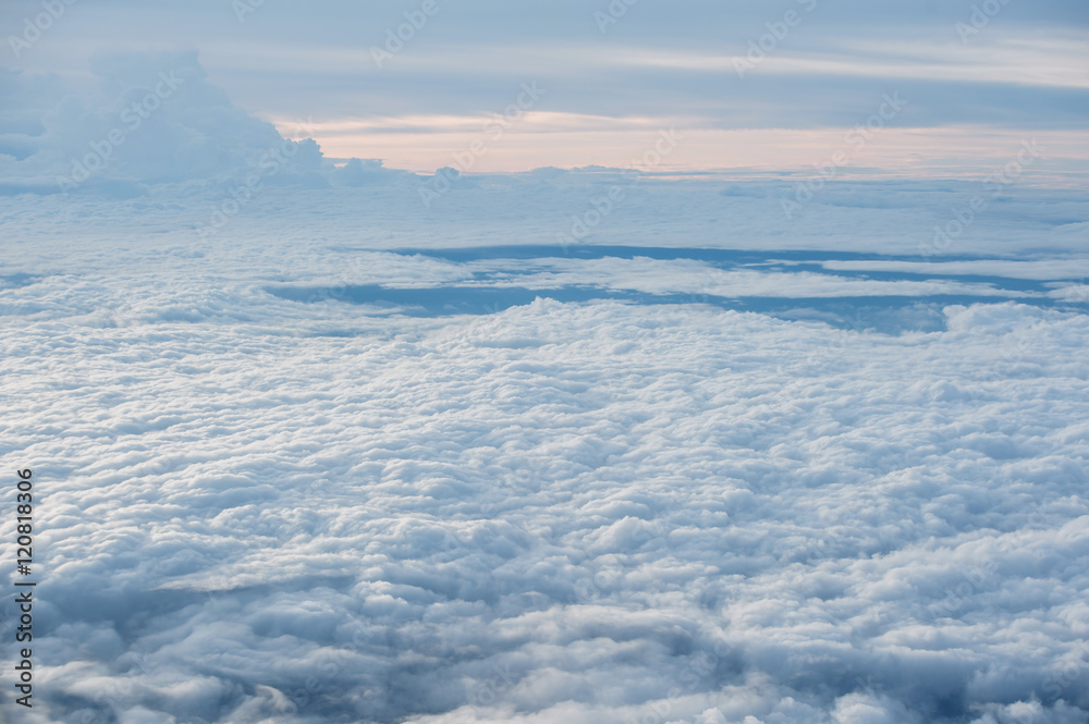 Clouds and sky as seen through window of an aircraft