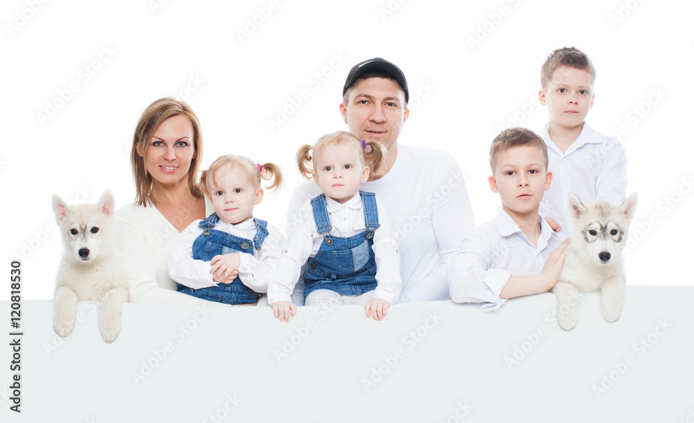Beautiful family, mom, dad, kids, son, daughter, kids, puppies husky, with blank board, isolation