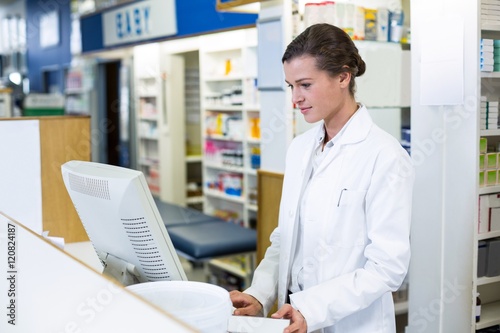 Pharmacist making prescription record through computer © WavebreakMediaMicro