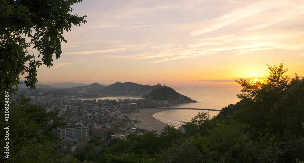 Sunset with red sun in the city of Donostia (San Sebastian), Spain.