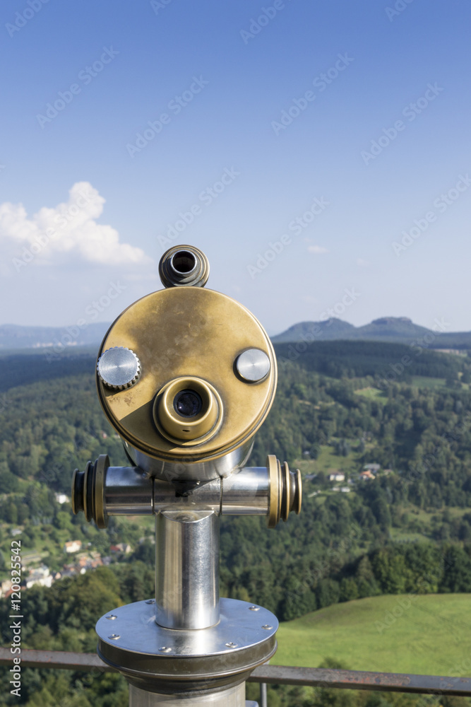 Public binocular telescope (binoscope) on the top of observation deck - view to the mountains landscape