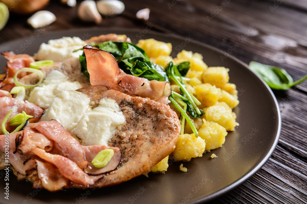 Roasted pork cutlets with bacon, cheese, spinach and potatoes Roasted pork cutlets with bacon, cheese, spinach and potatoes