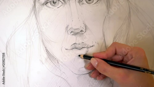 Close up of portrait drawing woman with pencil. Woman hand with pencil drawing woman portrait. 4k. photo