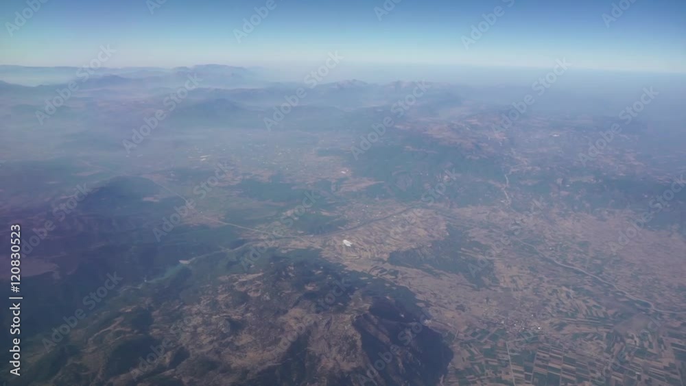 View through an airplane window. View from plane side window. Traveling by air.
