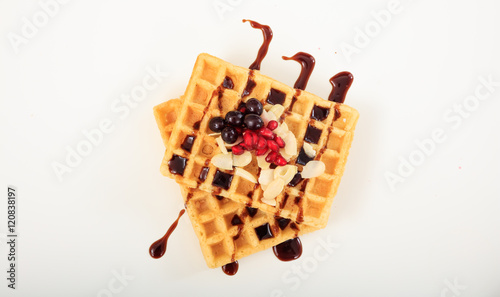 Waffle with syrup on white background