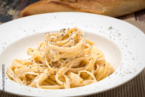 Canvas Print Fettuccine Alfredo classic Italian Pasta on a dark wood table..