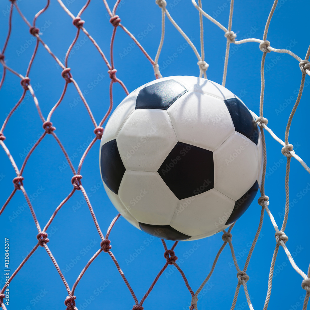 Naklejka premium soccer ball in goal net