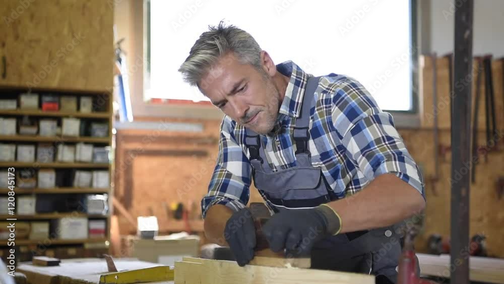 Carpenter working wood in workshop Carpenter working wood in workshop