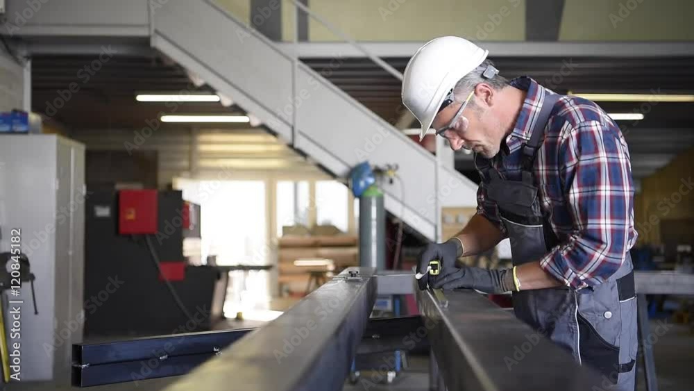 Metalworker with security helmet in workshop Metalworker with security helmet in workshop