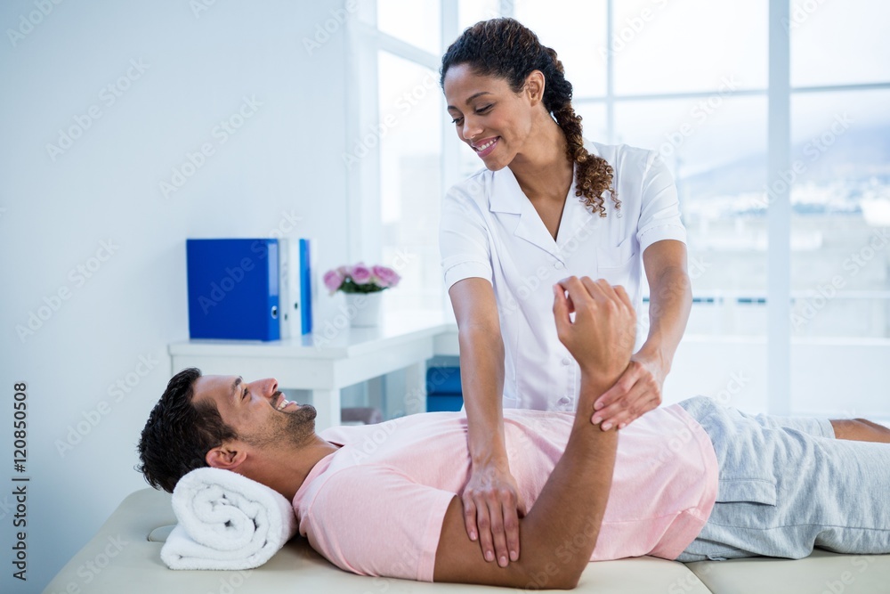 Fototapeta premium Physiotherapist giving hand massage to a patient