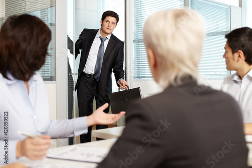 Office worker coming late to meeting photo