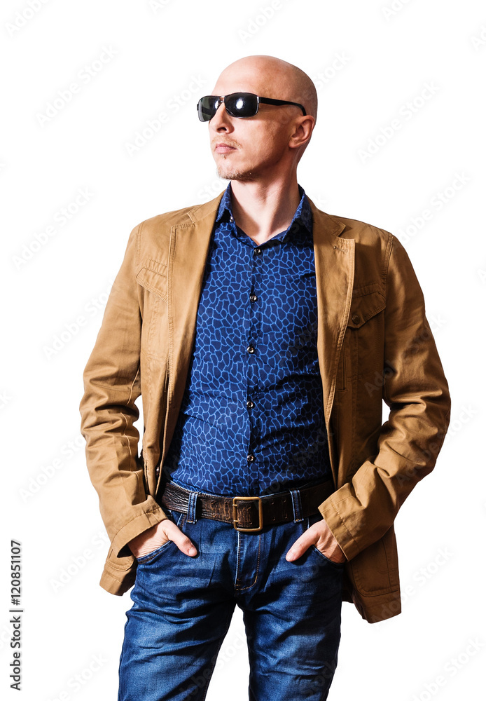 Skinhead man in sunglasses, yellow jacket and blue jeans posing with his  hands in his pockets Stock Photo | Adobe Stock