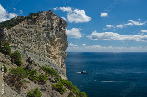 Yacht in the sea on blue sky background. Top view of Blue Bay and the mountains on the Black sea coast. Crimea.
