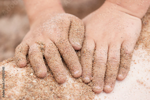 Hands in the sand on the beach