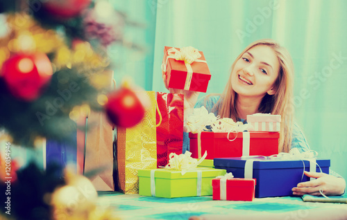 Portrait of happy girl with X-mas presents at home