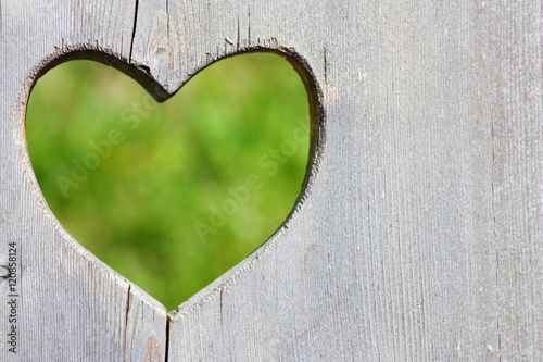 Wooden background with green heart