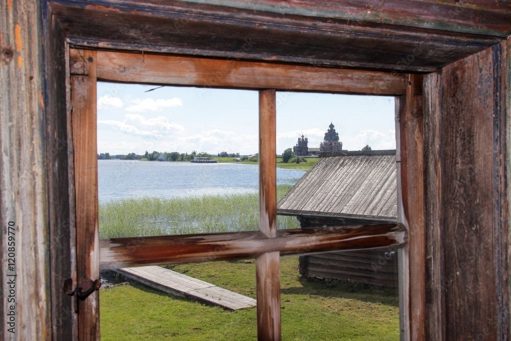 Kizhi pogost and Onega lake. View through the window from ancient wooden house