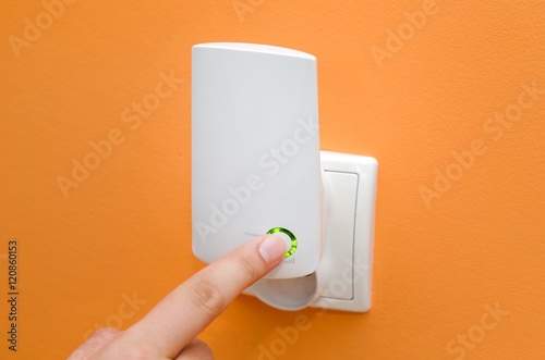 WiFi repeater in electrical socket. Simply way to extend wireles photo
