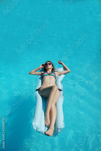 Young woman relaxing in pool