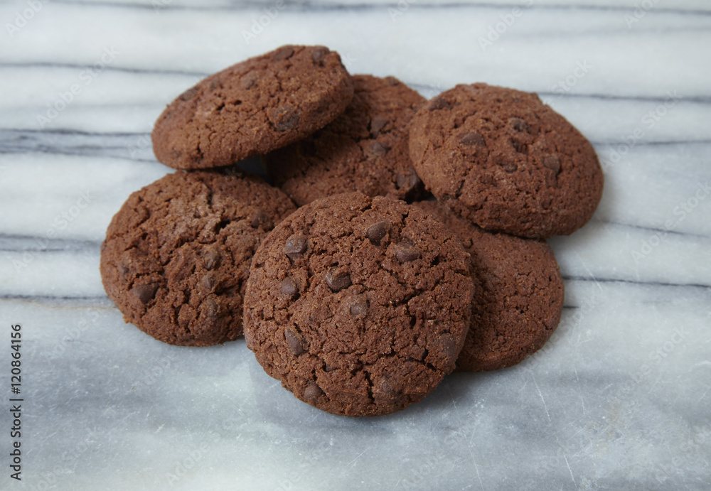 A pile of freshly baked chocolate chip cookies on a marble background A pile of freshly baked chocolate chip cookies on a marble background