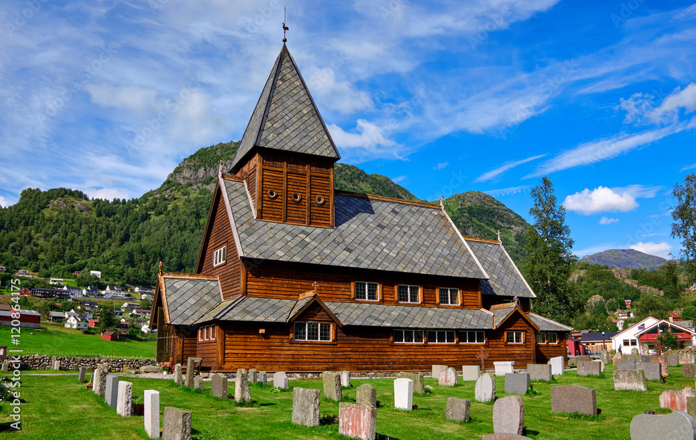 Roeldal old wood stave church and belonging cemetery in front of the town houses in Norway Roeldal old wood stave church and belonging cemetery in front of the town houses in Norway