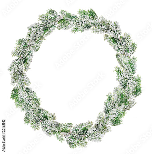 green Christmas wreath in snow isolated on white