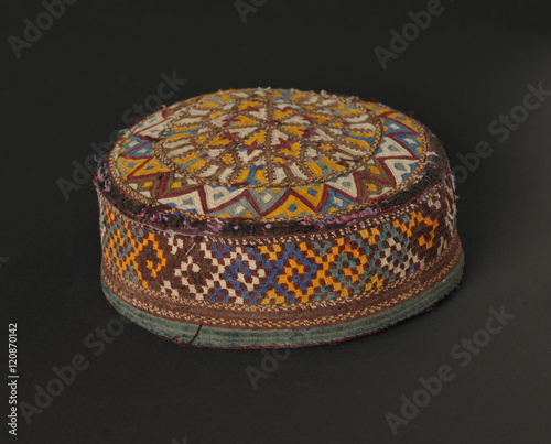 colorful traditional asian skullcap cap on a dark background