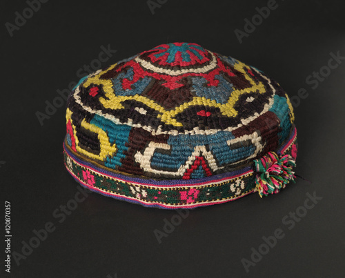 colorful traditional asian skullcap cap on a dark background