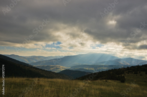 Heavy overcast sky over meadows and colorful forests at autumn, mountain Goc, Serbia