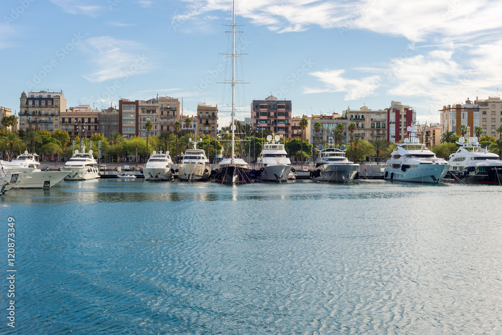 Fototapeta premium Luxury yachts moored in the marina Port Vell in Barcelona. The city is an important destination. Some yachts are rentable for incredible money