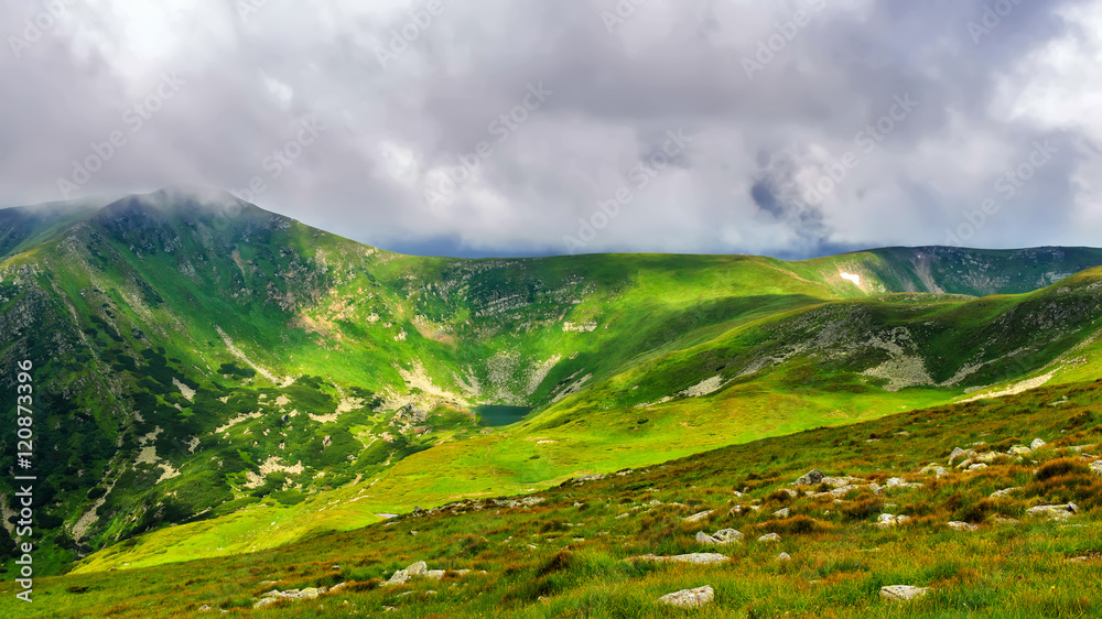Obraz premium Picturesque and dramatic Carpathian mountains under huge rain clouds, nature landscape in summer, Ukraine.