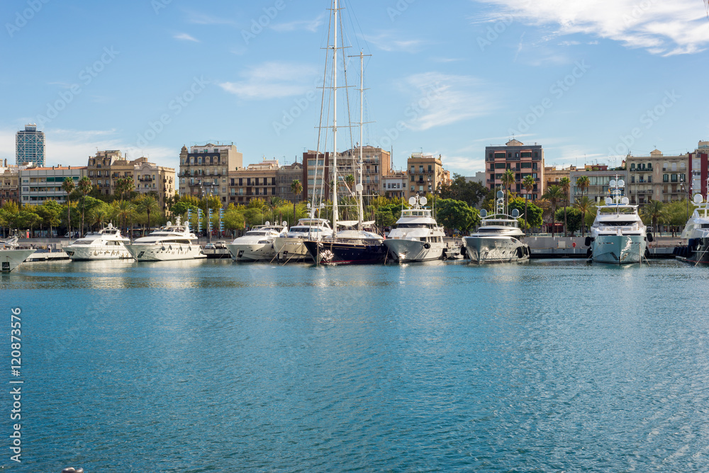 Fototapeta premium Luxury yachts moored in the marina Port Vell in Barcelona. The city is an important destination. Some yachts are rentable for incredible money