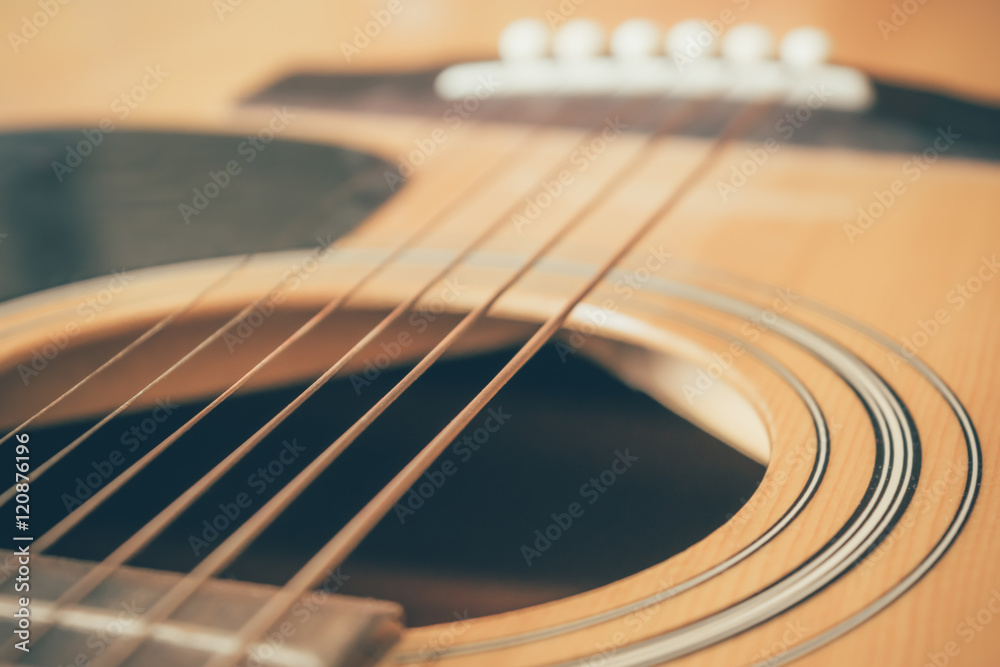 Obraz premium closeup picture of an acoustic guitar in a film tone