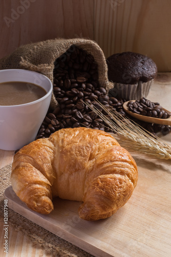 breaksfast and cup of coffee with coffee beans background. photo