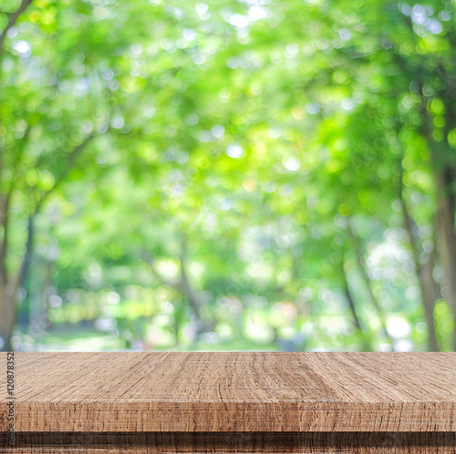 Empty wooden table over blurred tree with bokeh background