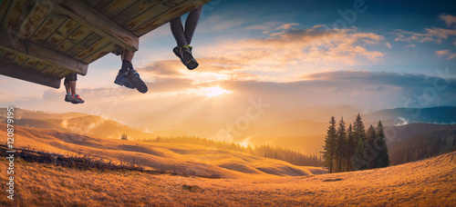 Hikers sit above the mountain valley