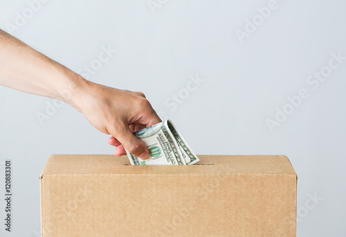 Slika na platnu man putting dollar money into donation box