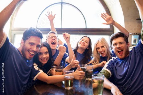 football fans or friends with beer at sport bar © Syda Productions