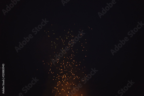 sparks from bonfire in the night with dark background
