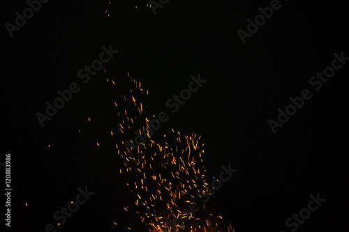 sparks from bonfire in the night with dark background