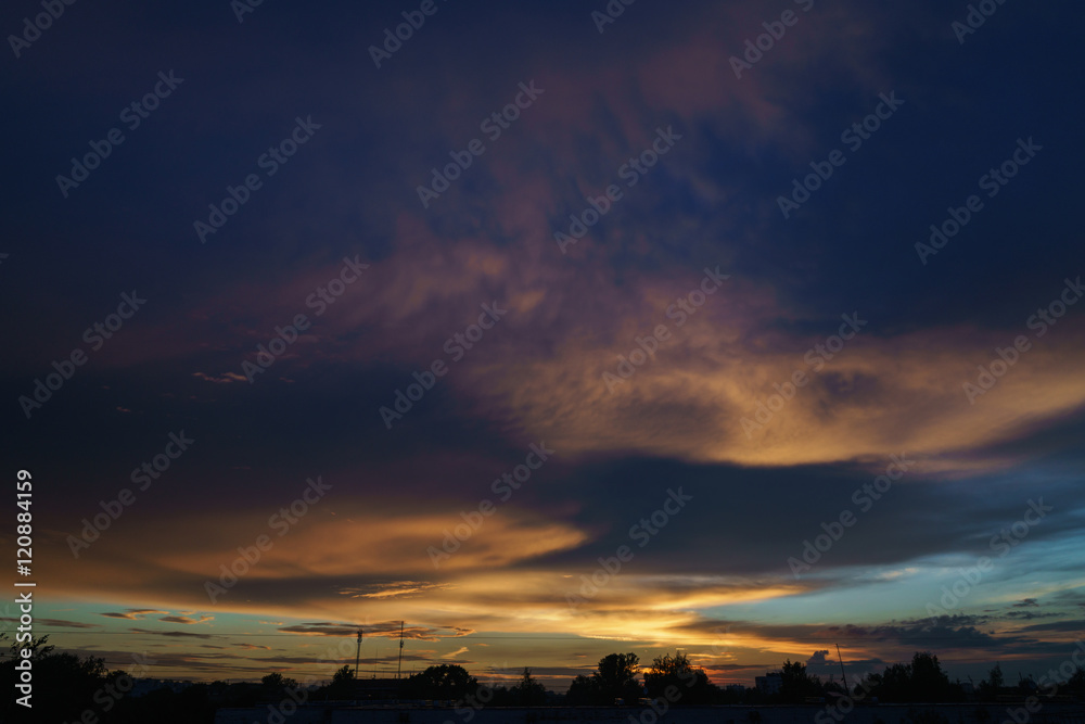 Fototapeta premium sunset clouds and colored sky over town