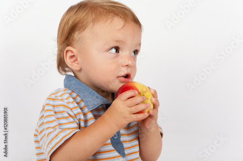 Adorable baby eating apple