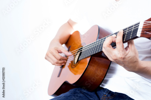 asian young musician playing acoustic guitar