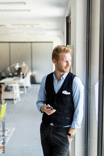 Young man with mobile phone...