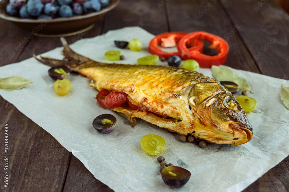 Baked fish carp, stuffed bell peppers and grapes. Baked fish carp, stuffed bell peppers and grapes.