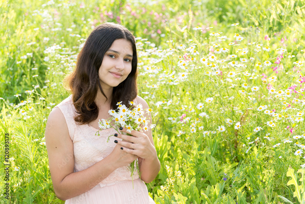 Girl teenager with bouquet of daisies on summer meadow Girl teenager with bouquet of daisies on summer meadow
