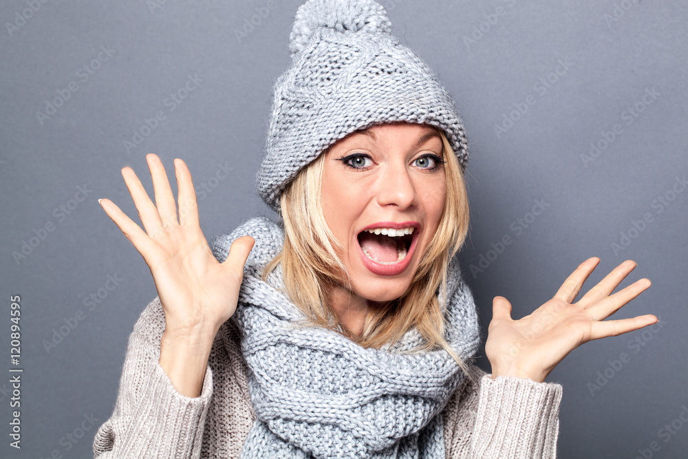 surprised young woman with winter scarf and hat having fun surprised young woman with winter scarf and hat having fun