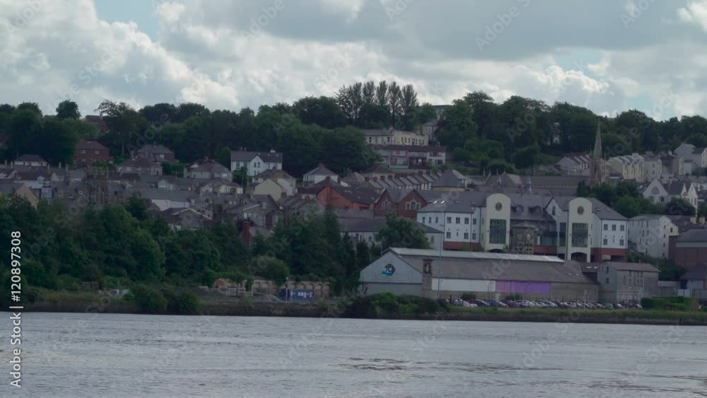 The houses on the riverside in Londonderry. Derry also known as Londonderry is a city on the River Foyle in Northern Ireland. The houses on the riverside in Londonderry. Derry also known as Londonderry is a city on the River Foyle in Northern Ireland.