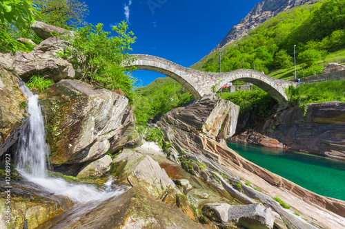 Double arch stone bridge at Ponte dei Salti with waterfall, Lavertezzo, Verzascatal, Canton Tessin. photo