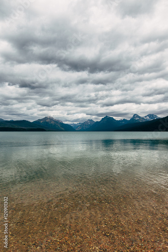 Lake McDonald¬†against cloudy sky